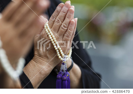 A woman visiting a grave 42886470