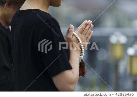 A woman visiting a grave 42886486