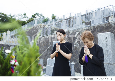 A woman visiting a grave A woman visiting a grave 42886504