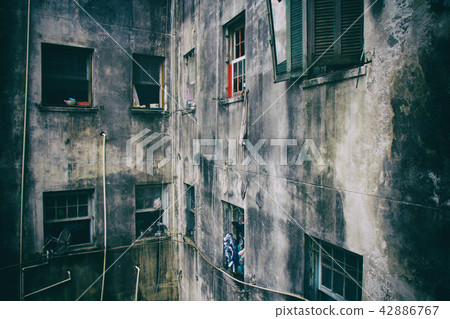 Ruined walls and windows of a residential building 42886767