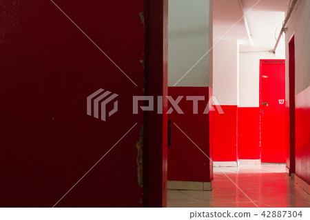 Red and white corridor and  wall with sun light. 42887304