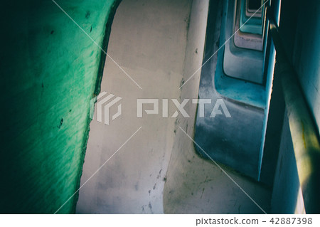 Spiral staircase in a decayed building. 42887398