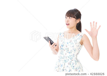 A woman with a dangerous eye on a walking smartphone A woman with a dangerous eye on a walking smartphone 42888826