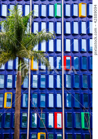 Blue building with red, yellow and green windows Blue building with red, yellow and green windows 42889094