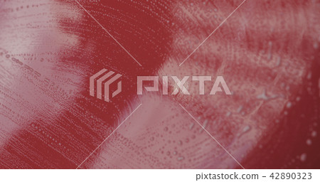 Closeup red car wash shampoo soak 42890323