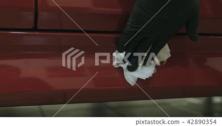 closeup of car paint degreasing with alcohol before polishing 42890354
