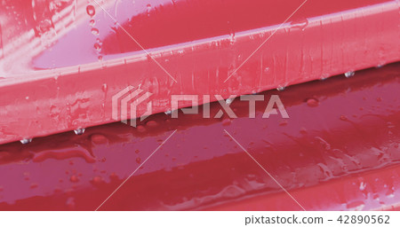 Closeup focus red car wash degreasing paint soak 42890562