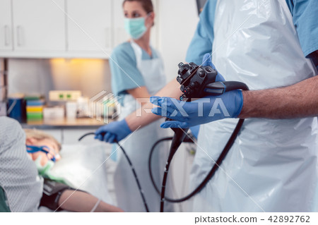 Team of doctors performing endoscopy in hospital 42892762