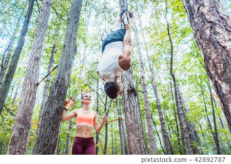 Man and woman doing functional fitness in outdoor gym 42892787