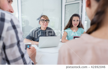 Reliable young co-workers thinking of solutions and successful ideas Reliable young co-workers thinking of solutions and successful ideas 42892846