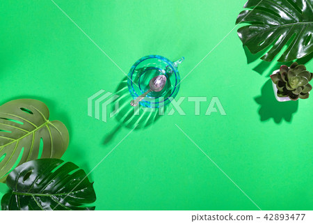 Workspace frame with green tropical leaf and cup 42893477