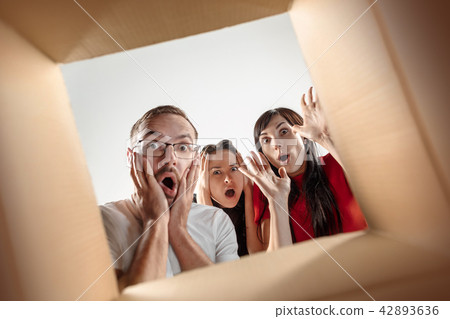 The people unpacking and opening carton box and looking inside The people unpacking and opening carton box and looking inside 42893636