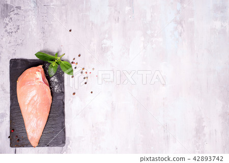Raw chicken breast on a slate plate, Raw chicken breast on a slate plate, 42893742