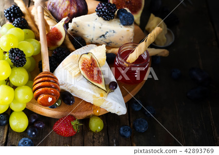 Cheese plate served with wine, jam and stick 42893769