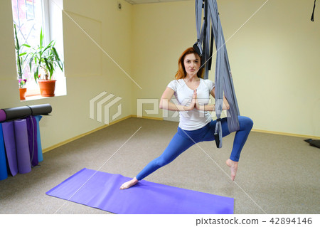 girl performs in air acrobatic elements. 42894146