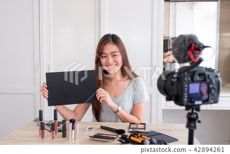 Asian young female blogger giveaway gift fan 42894261
