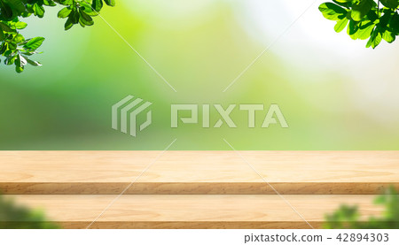 step plank wood table top with blur tree in park step plank wood table top with blur tree in park 42894303