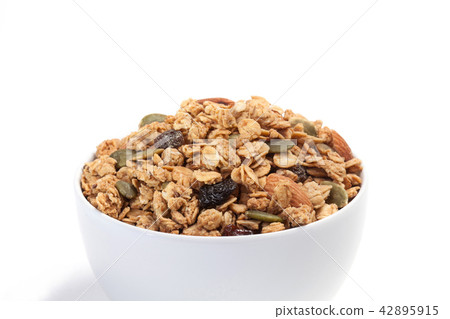 Close up Granola on white bowl isolated on white Close up Granola on white bowl isolated on white 42895915