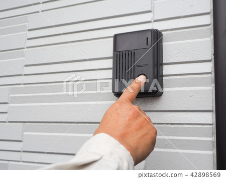 The hand of the worker pressing the door chime The hand of the worker pressing the door chime 42898569