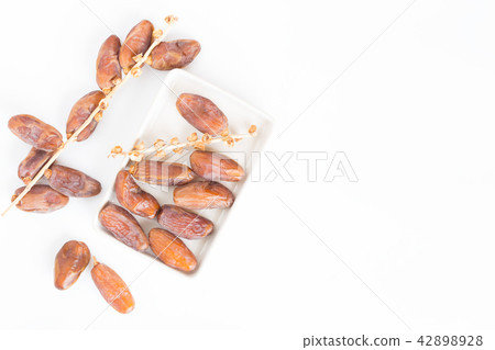 Dates fruit in ceramic bowl white background Dates fruit in ceramic bowl white background 42898928