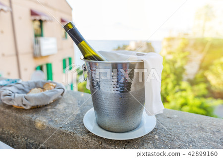 a bottle of wine in an ice bucket 42899160