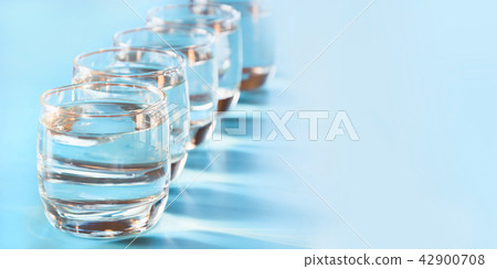 Glasses of water on blue. Close up.  42900708