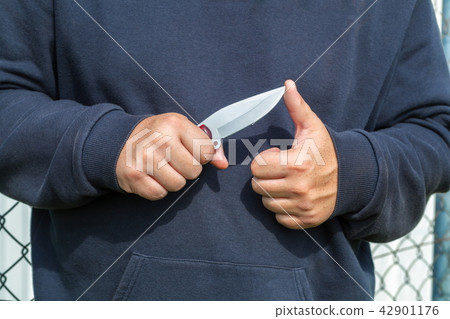Man checking knife sharpness Man checking knife sharpness 42901176