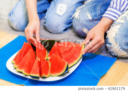Family eating watermelon on floor 42901179
