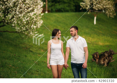 Dating in park. Love couple standing together on grass near the lake. Romance and love Dating in park. Love couple standing together on grass near the lake. Romance and love 42901310