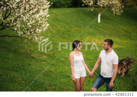 Dating in park. Love couple standing together on grass near the lake. Romance and love Dating in park. Love couple standing together on grass near the lake. Romance and love 42901311