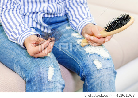 Woman with hair in hand.Hair loss concept Woman with hair in hand.Hair loss concept 42901368