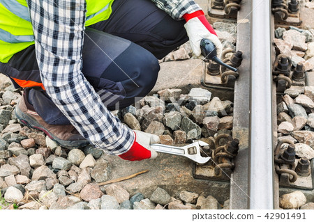 Worker using wrench on railway Worker using wrench on railway 42901491