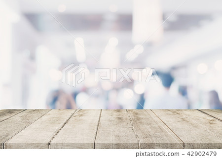 Empty wooden table with blurred abstract people Empty wooden table with blurred abstract people 42902479