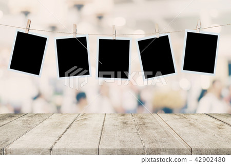 Empty wood table and instant photo hanging Empty wood table and instant photo hanging 42902480