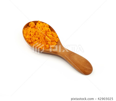 Wooden scoop spoon full of yellow turmeric powder 42903025