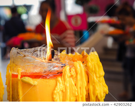 Yellow candles burning in old church. Yellow candles burning in old church. 42903262