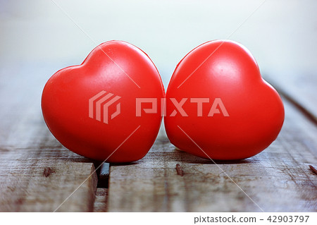 Two red heart on wood table. 42903797