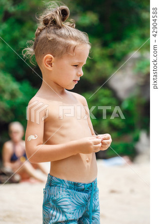 little serious boy standing on the beach little serious boy standing on the beach 42904588