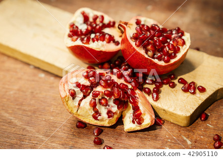 pomegranate fruit on an old wooden table pomegranate fruit on an old wooden table 42905110