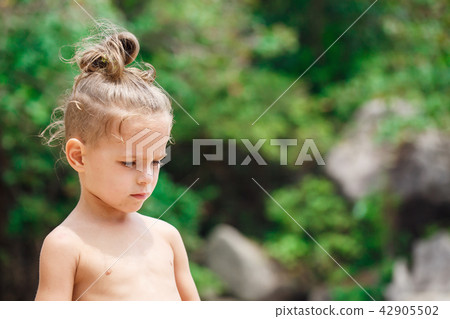 little serious boy standing on the beach little serious boy standing on the beach 42905502