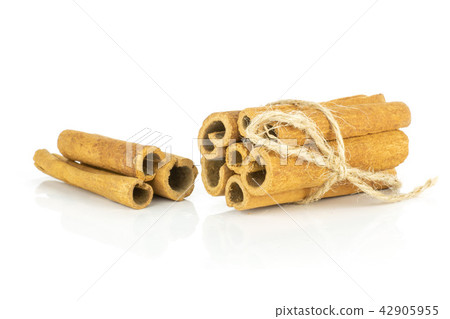 Dry brown cinnamon stick isolated on white Dry brown cinnamon stick isolated on white 42905955
