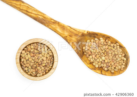 Raw green lentil seeds isolated on white Raw green lentil seeds isolated on white 42906360