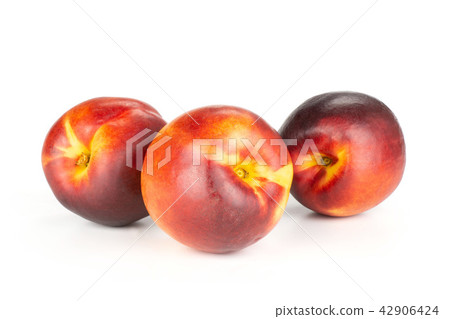 Ripe deep red nectarine isolated on white Ripe deep red nectarine isolated on white 42906424