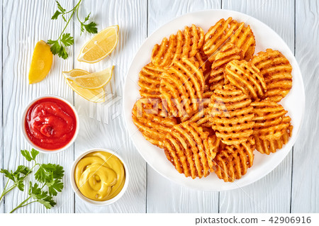 Crispy Potato Waffles Fries, top view Crispy Potato Waffles Fries, top view 42906916