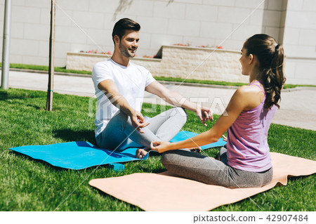 Delighted nice couple enjoying yoga Delighted nice couple enjoying yoga 42907484
