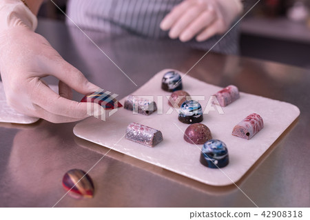 Professional confectioner making very creative chocolate sweets Professional confectioner making very creative chocolate sweets 42908318