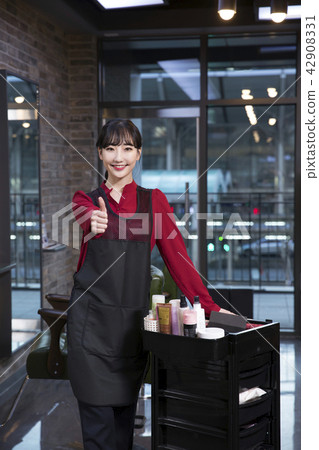 Hairdresser styling woman's hair in a salon. Korean beauty stock photo. 187 42908331