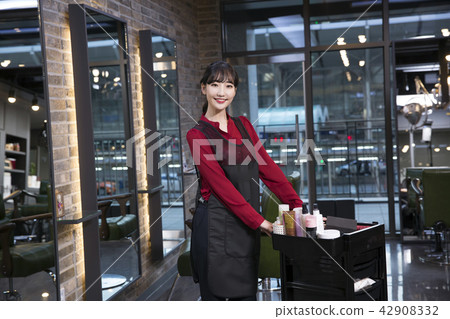 Hairdresser styling woman's hair in a salon. Korean beauty stock photo. 186 Hairdresser styling woman's hair in a salon. Korean beauty stock photo. 186 42908332