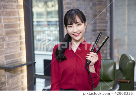 Hairdresser styling woman's hair in a salon. Korean beauty stock photo. 166 Hairdresser styling woman's hair in a salon. Korean beauty stock photo. 166 42908336