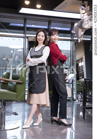 Hairdresser styling woman's hair in a salon. Korean beauty stock photo. 173 Hairdresser styling woman's hair in a salon. Korean beauty stock photo. 173 42908353